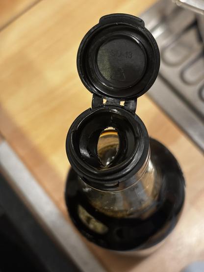photo of the flow restriction of a soy sauce bottle
it has an oval shape, vaguely suggesting a pussy