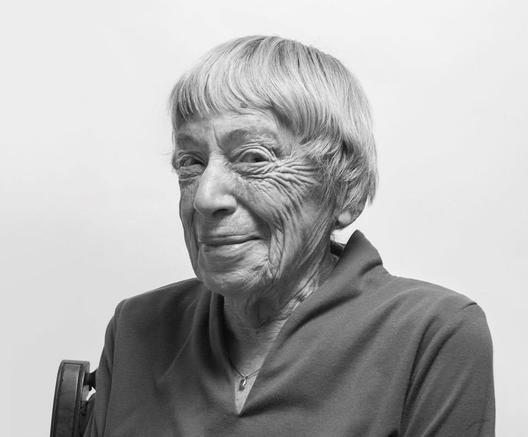 Black and white photo of Ursula Le Guin with a mischievous smile on her face.