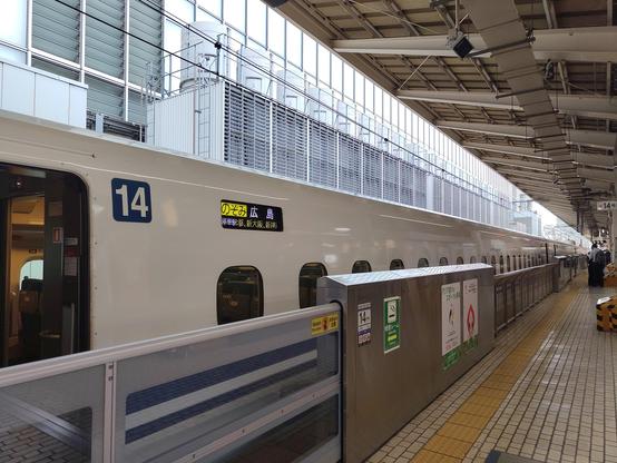 Photo du train shinkansen à quai, avec l'écran indiquant le nom du train et sa destination.