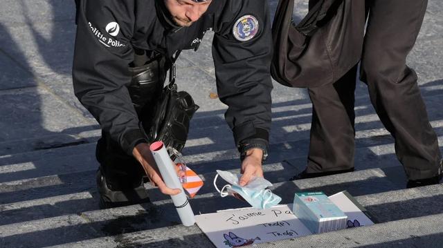policier ramasser des masques chirurgicaux et une boîte de sérum physiologique à Bruxelles, le samedi 24 octobre 2026